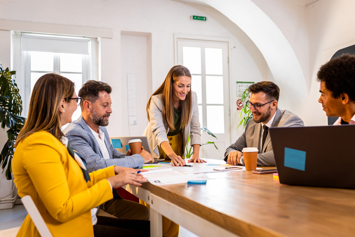 Group of advisors around a conference table enjoying working with one of the top commercial real estate brokerage firms
