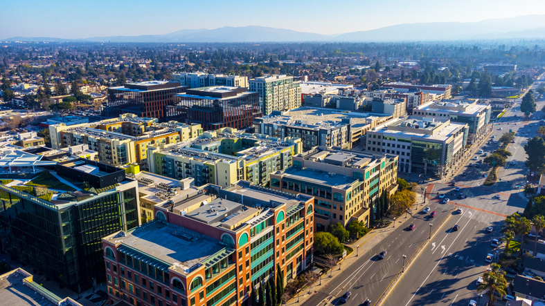 Aerial view of a mid-size downtown with mixed-use and office buildings, the kind of market commercial real estate transaction analytics track