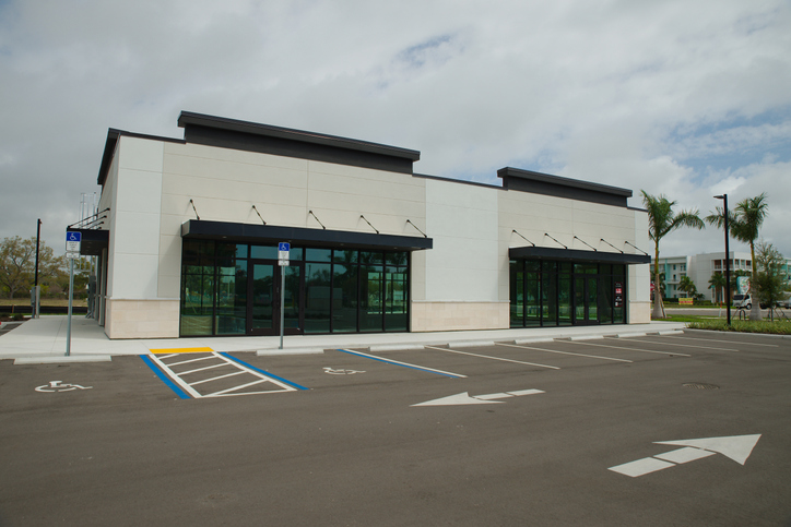 Modern single-tenant retail building with parking, an example of the net lease investment properties investors evaluate.